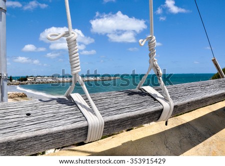 Flag Rope Lines knotted to wooden post and a blue sky/Flag Rope Lines/Knotted Detail