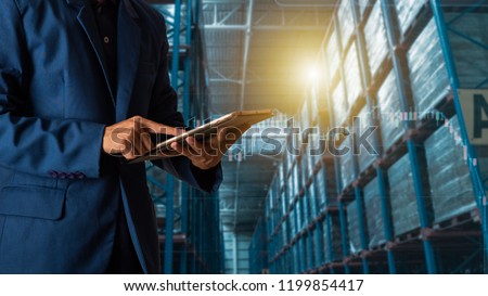 Industry 4.0 concept Logistic and transport concept : Businessman manager using tablet check and control and planning for Modern Trade warehouse logistics.