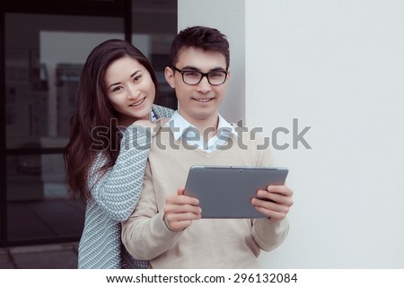 smart students man and woman student studying with pc Outside Building at college