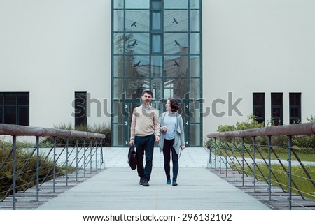 smart students man and woman student walking outdoor