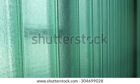 Interior face of green frosted glass wall