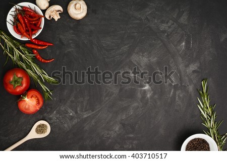 Black table with food ingredients and utensil, top view frame style