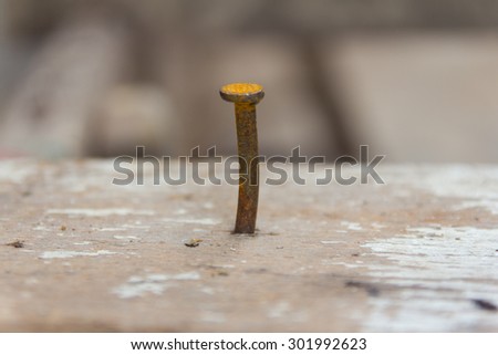 The rusty iron nails was nailed on wood , soft color , In center this image
