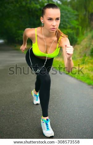 The girl stands at the start, to run right now. She is sure that will come running first