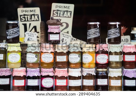 STAITHES, ENGLAND -  MAY 5: Colorful glass jars of jams, chutneys and sauces stacked in a shop window 5 May, 2015 in the High Street, Staithes, North Yorkshire, England.