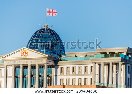 TBILISI - SEPTEMBER 26: The Georgian flag flies boldly above the green glass dome of the Georgian Presidential Palace in the nation\'s capital, Tbilisi, Georgia, September 26, 2014.