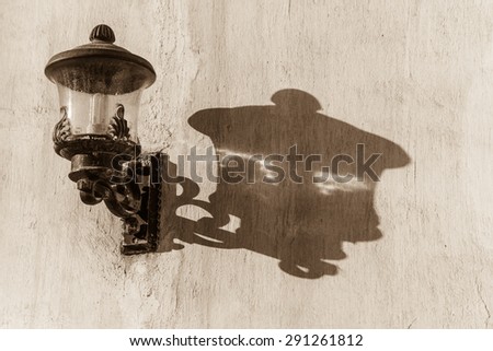 The sun casts the shadow of a lamp on the adobe wall of the Isa bin Ali house, Muharraq, Bahrain.