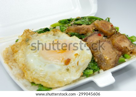 Thai popular menu for packed lunch, Kana Moo Grob Khai Dao. Stri-fried crispy pork with Kale, eat with steamed rice and fried egg.