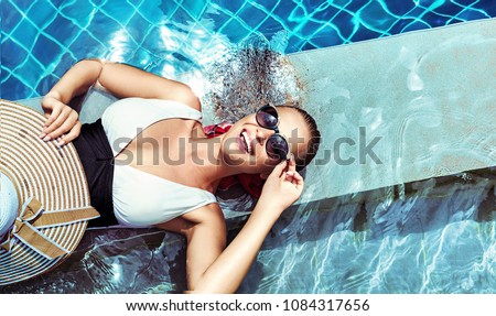 Young beautiful lady posing at swimming pool