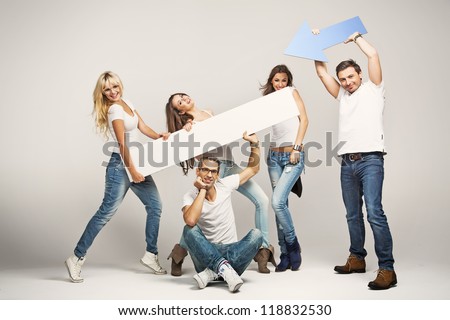 Happy casual people with white empty board