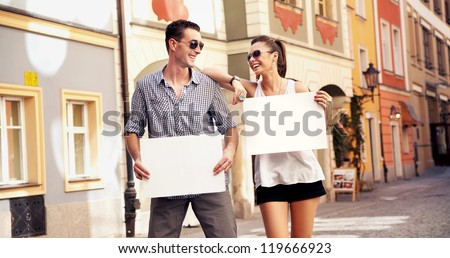 Two young people with empty advert boards