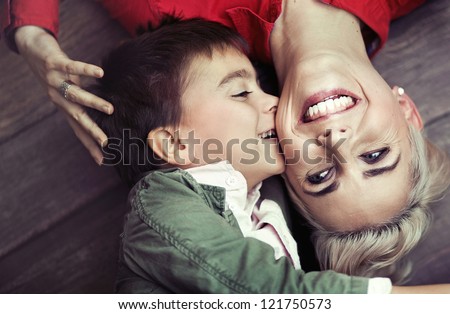 Young boy kissing her mum