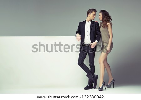 Young couple with big advert