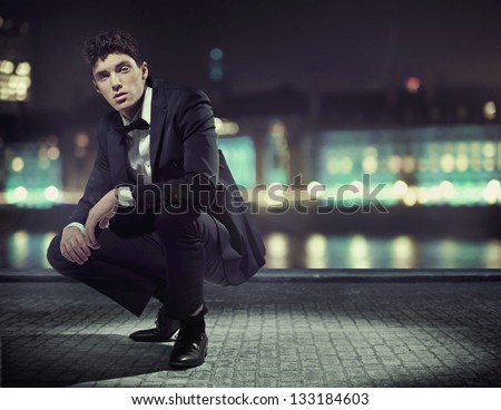 Handsome man over night city background