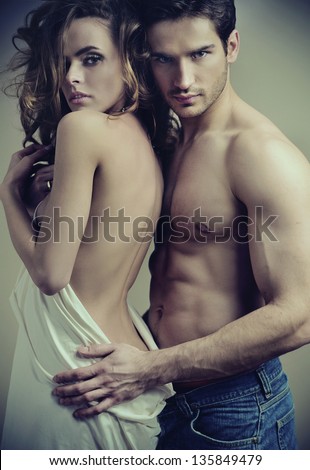 Fashion portrait of beautiful young lovers - stock photo