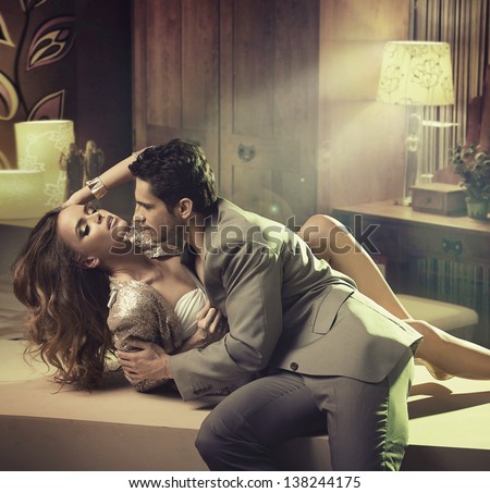 Young handsome man kissing his girlfriend