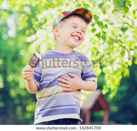 happy kid boy eating ice cream