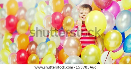 Small boy with bunch of balloons