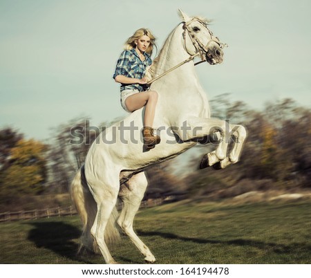 Portrait Of Young Beautiful Woman Riding Horse