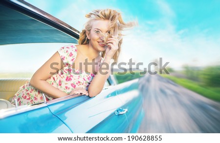 Young woman driving vintage car