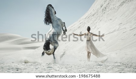 Woman with a white horse on a desert