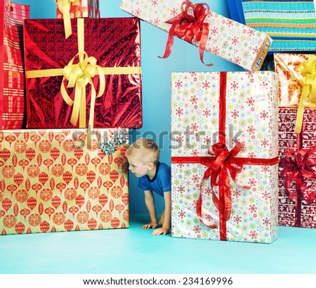 Smiling funny child with big gifts