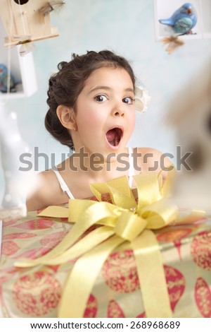 Cute little girl with a gift