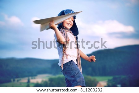 Happy kid playing with paper airplane