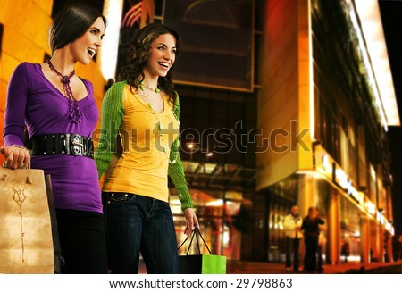 Two beautiful girls over shopping center at the evening