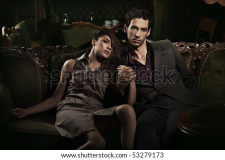 Handsome couple sitting on sofa