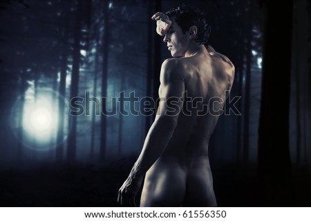 Fine art photo of a young muscular man  in a forest