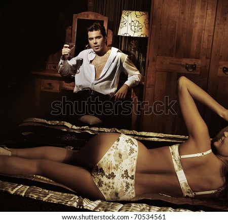 Sexy couple in bedroom - stock photo