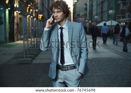 Young handsome man on evening city street