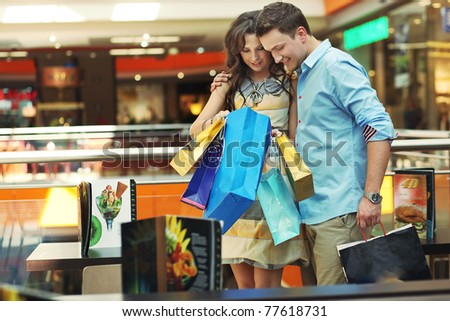Young couple checking their shopping bags