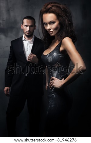 Fashionable couple in a dark room