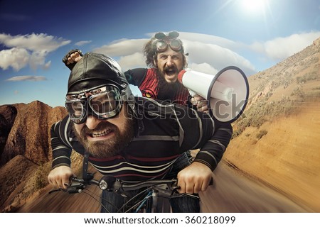 Two nerdy guys riding on a bike