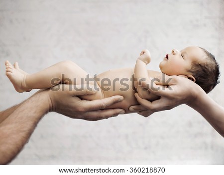 Newborn baby sleeping on parents hand