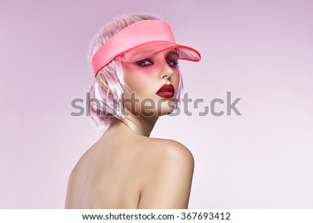 Portrait of glamour girl with red lips isolated on pink background