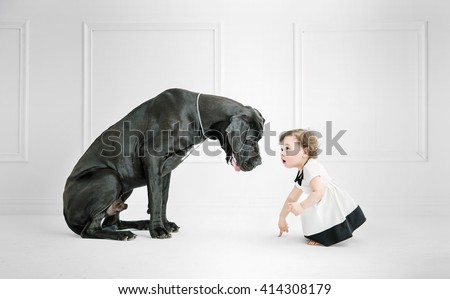 Little girl posing against a big dog