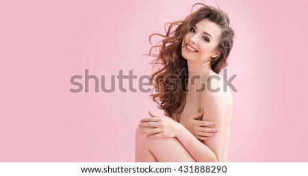 Naked brunette beauty over pink background