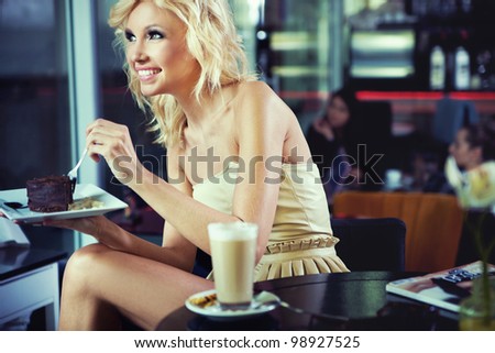 Cheerful blond beauty in a coffee shop