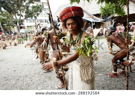 Honiara, Solomon Islands, June 21, 2014, a traditional dancing group from Temotu province performs at the museum area. The woman carries a traditional roll of \'feathermoney\