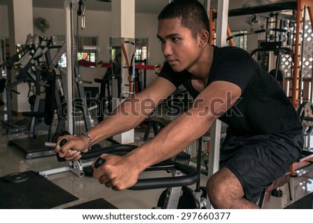 man exercise in the gym, cycling posture.