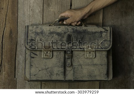 Handle Bag dusty old wooden backdrop.