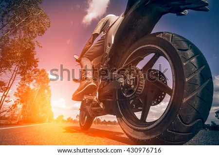 Driving a motorcycle in a sunny day.