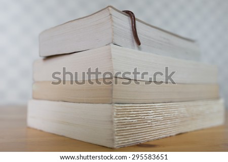Bookworm. Real earthworm hanging over books on wooden table 5