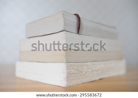 Bookworm. Real earthworm hanging over books on wooden table 3