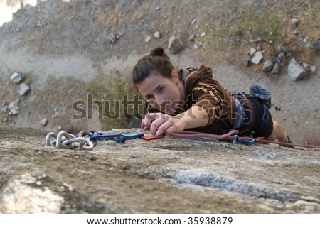 Rock climbing woman climbing on a rock face