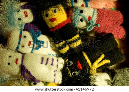 Group of finger knitted old finger puppets staring