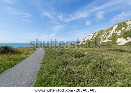 A deserted path leading to a beach at Samphire Hoe, near Dover, UK.  Also visible is part of the famous white chalk cliffs of dover.